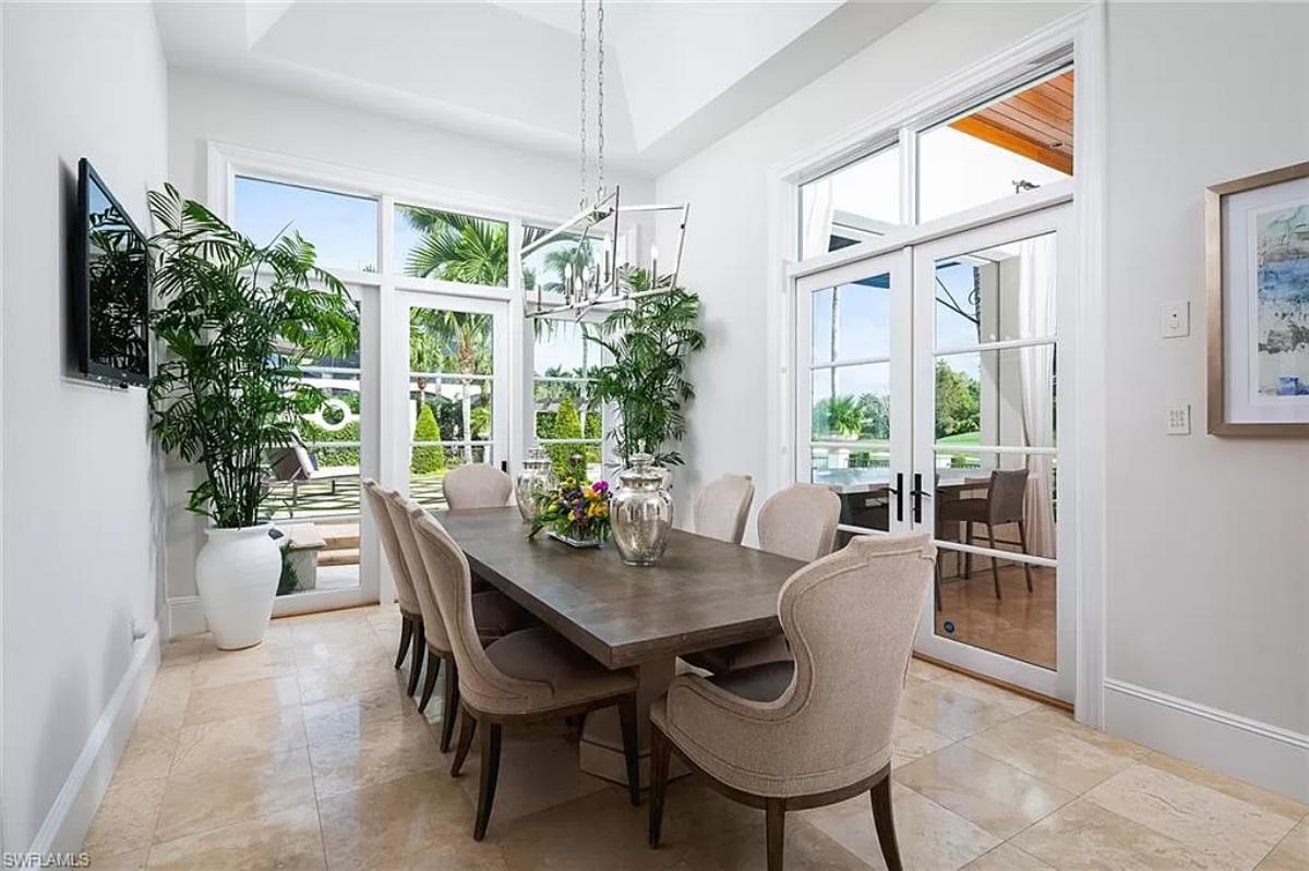 Dining room with a large wood table and chairs.