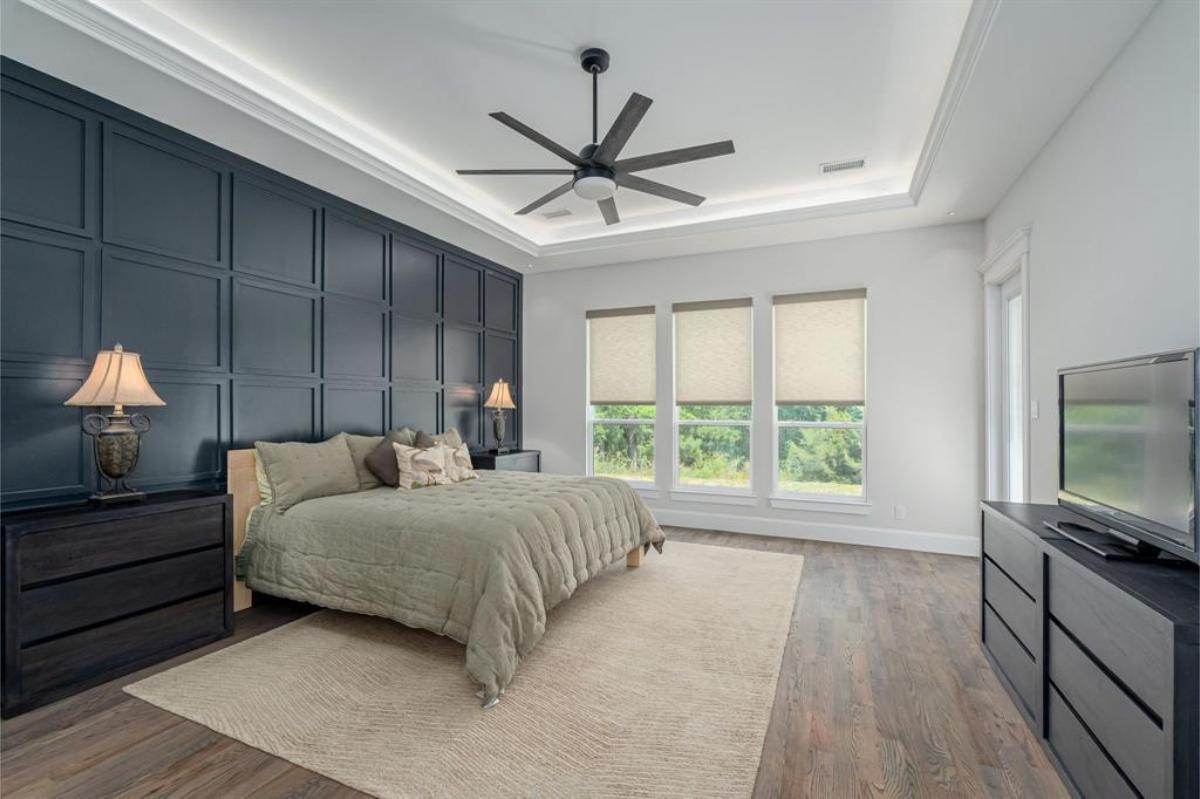 Bedroom with hardwood floors and glass windows.