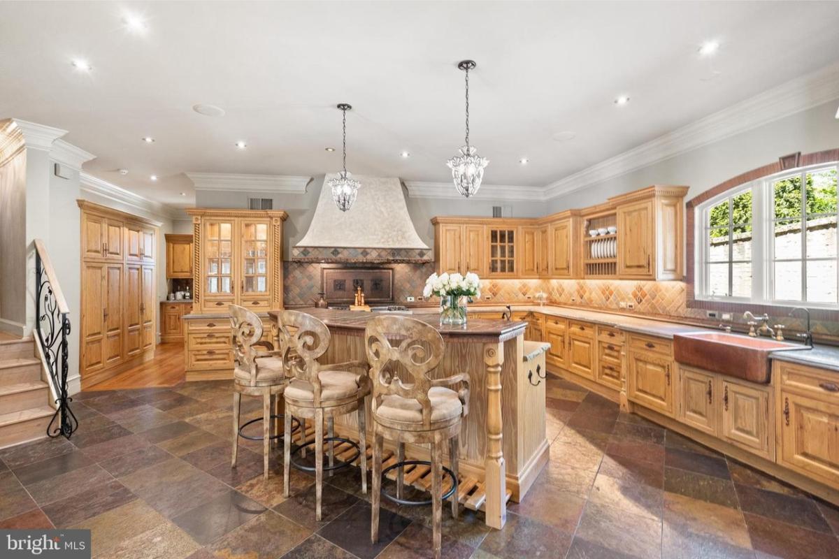 Kitchen with custom cabinetry and a counter breakfast bar.