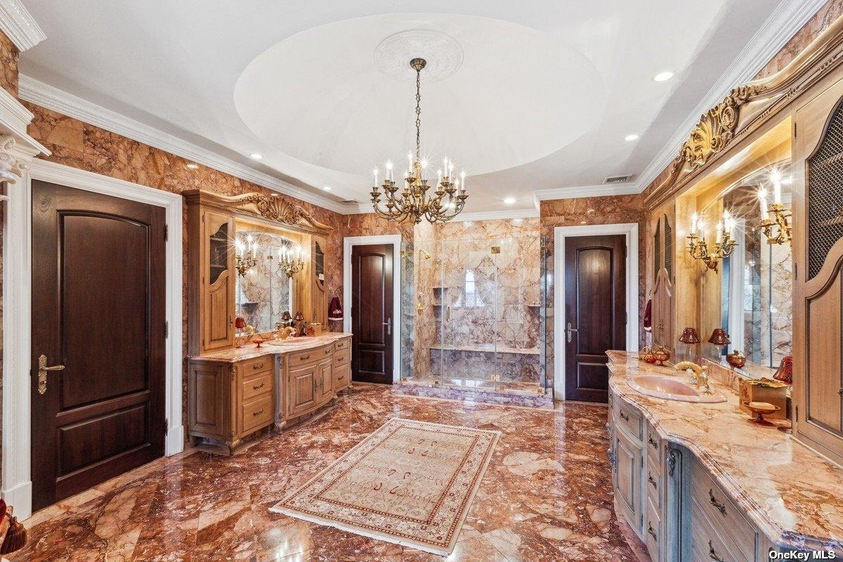 Bathroom with custom-made vanities and a walk-in shower