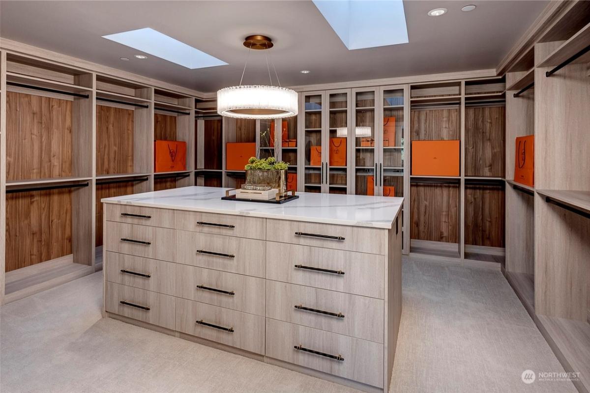 Walk-in closet with a chandelier.