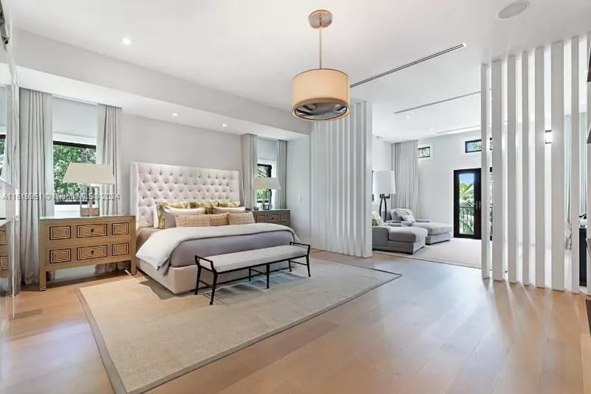 Bedroom with hardwood floors and private living space.