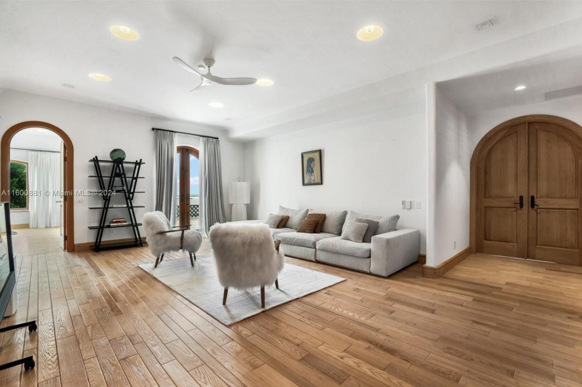 Living room with hardwood floors and glass doors.