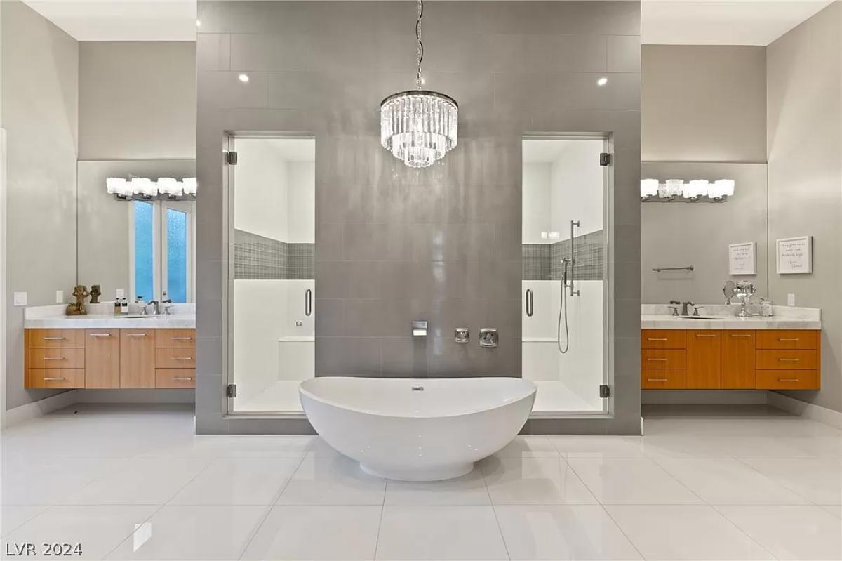 Bathroom with sinks, soaking tub and a walk-in shower.