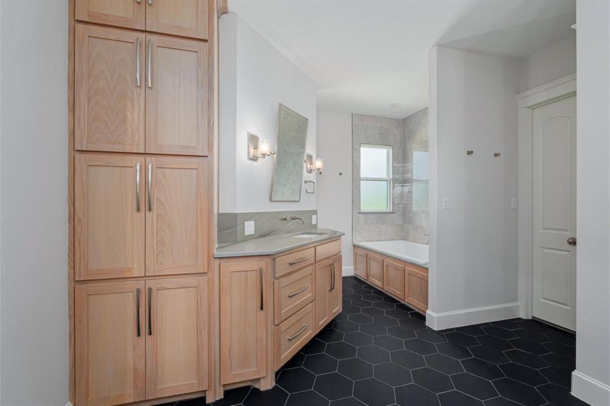 Bathroom with a custom-made vanity and a soaking tub.