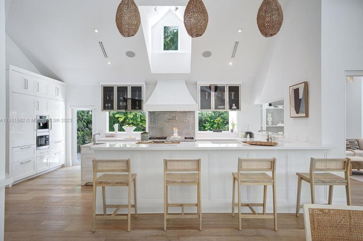 Kitchen with custom cabinetry, skylight and a counter breakfast bar.