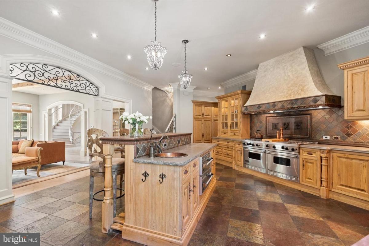 Kitchen with custom cabinetry and a counter breakfast bar.