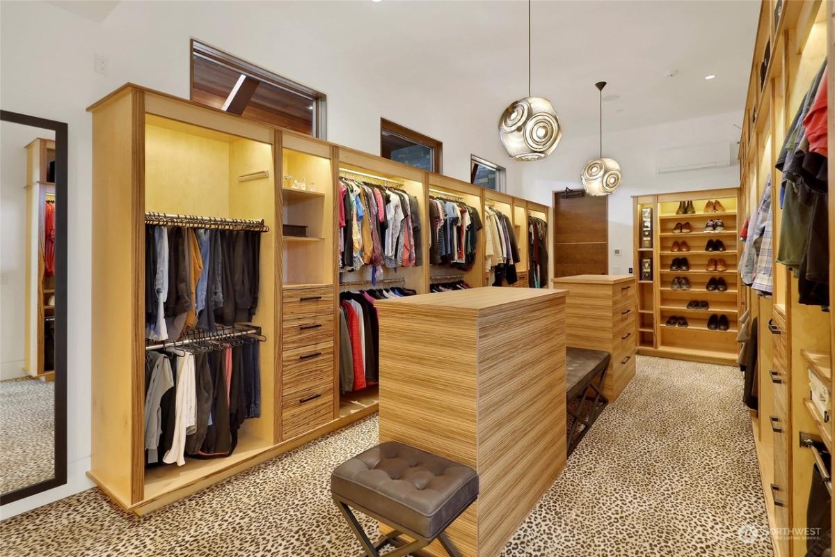 Walk-in closet with carpet floors.