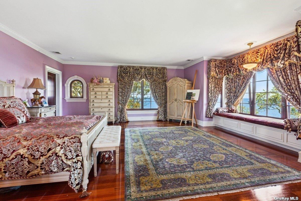 Bedroom with hardwood floors and glass windows.