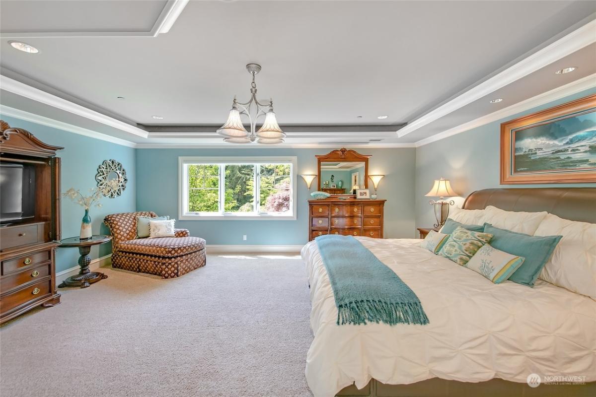 Bedroom with a large bed and carpet flooring.