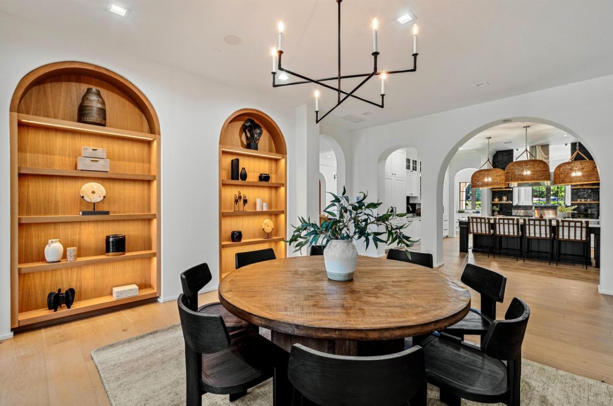 Breakfast nook with a round wood table.