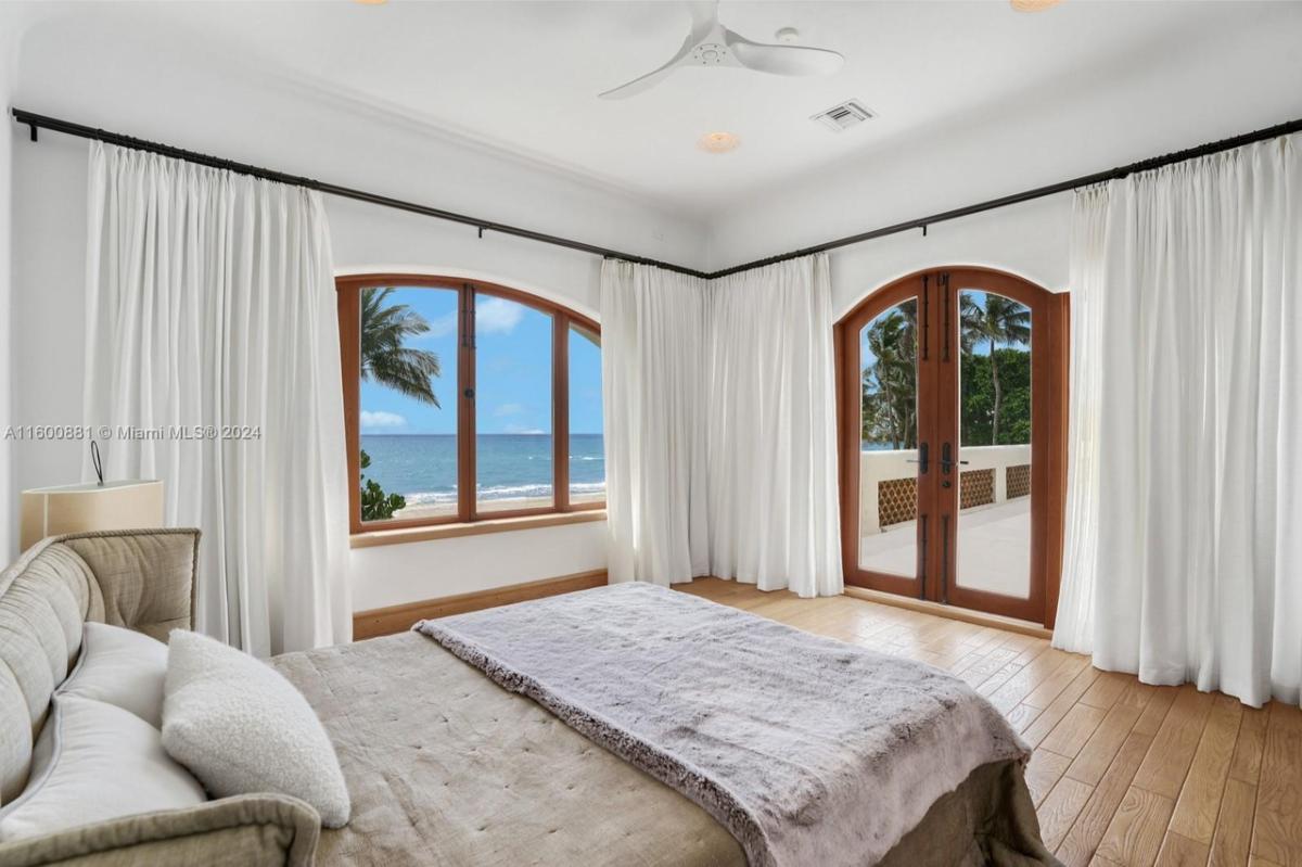 Bedroom with hardwood floors and glass doors.