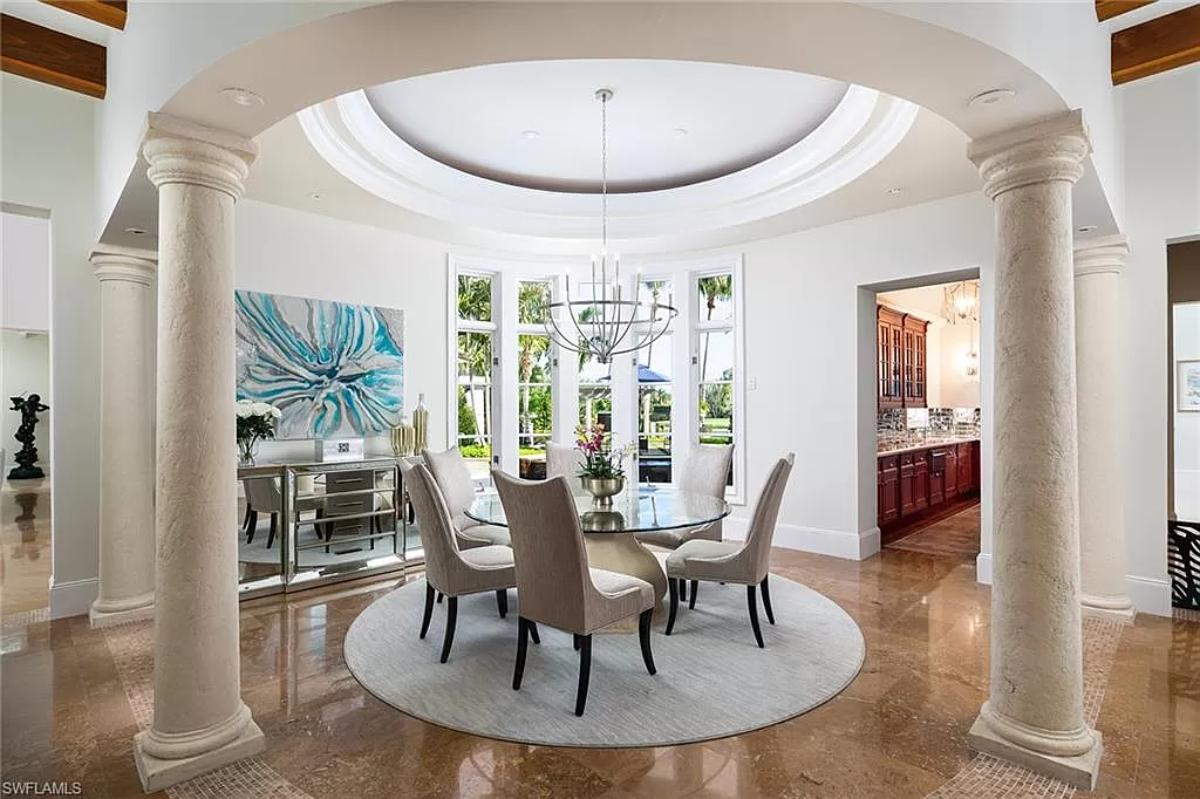 Breakfast nook with a round glass table.