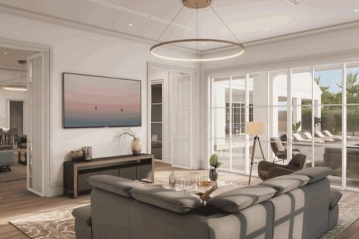 A living room with a painting, cabinet, couch, chair, and center table.