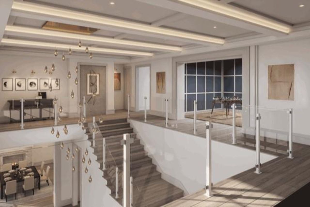 A landing with wooden floors and a glass handrail.