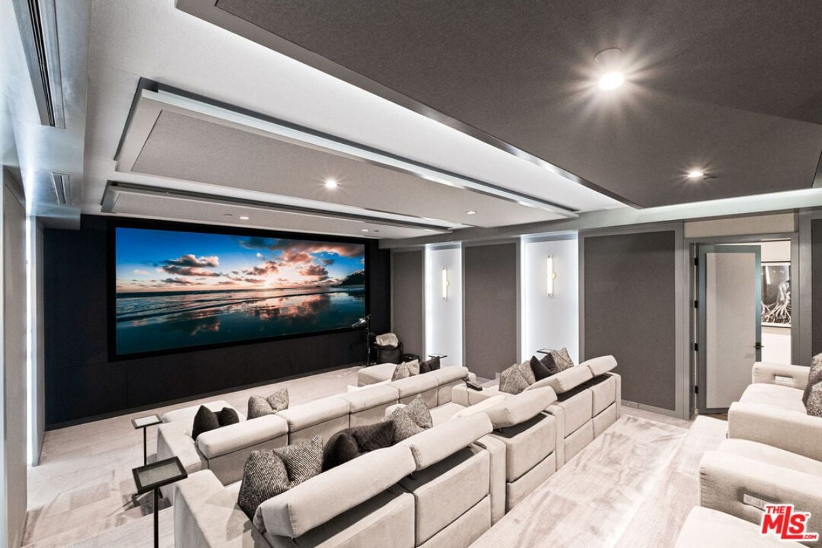 The home theater includes a large screen and cinema seats.