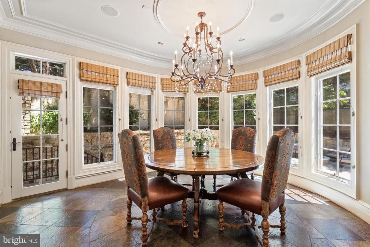Breakfast nook with a chandelier and glass windows.