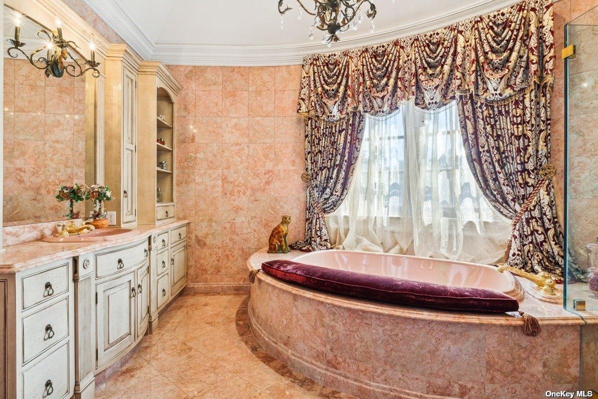 Bathroom with a custom-made vanity and a soaking tub.