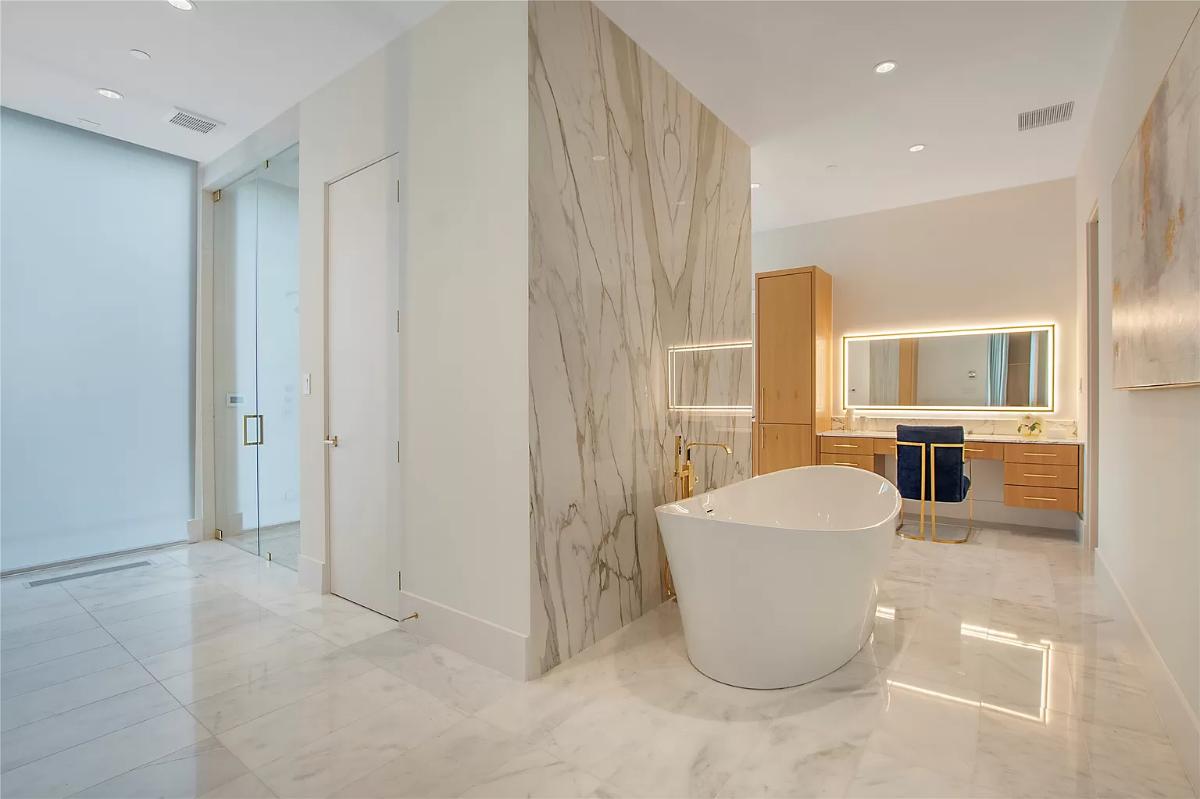 Bathroom with a custom-made vanity and a soaking tub.