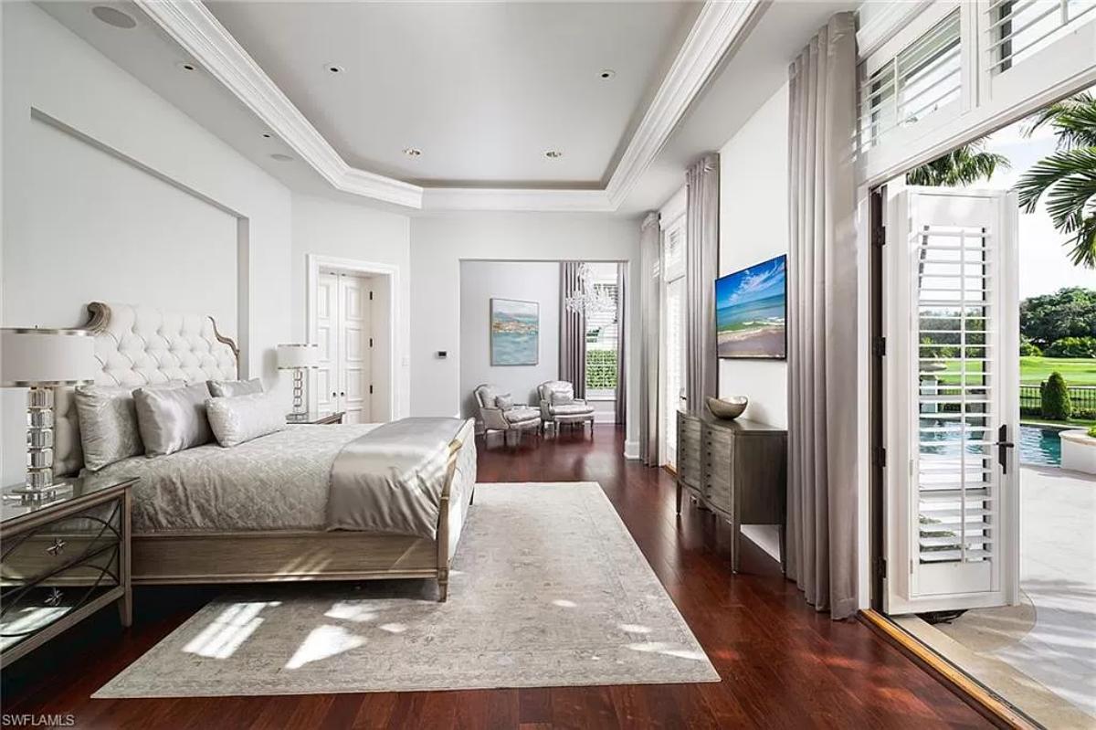 Bedroom with hardwood flooring and custom lighting.
