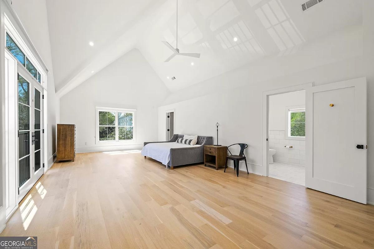 Spacious bedroom with hardwood floors.