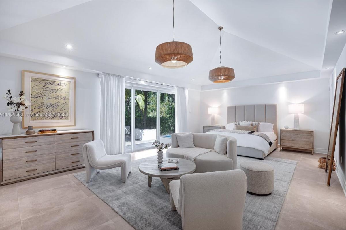 Bedroom with sliding glass doors and a private living space.