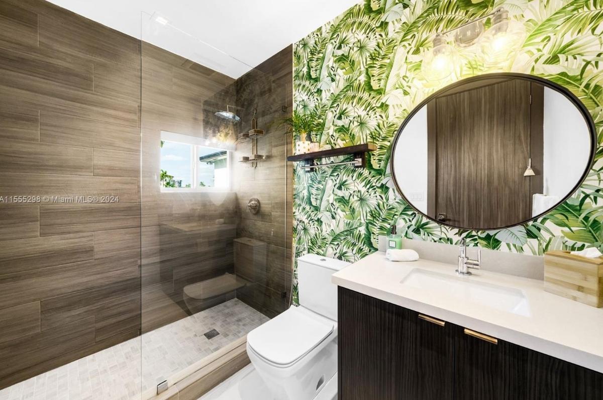 Bathroom with a sink, toilet and a walk-in shower.
