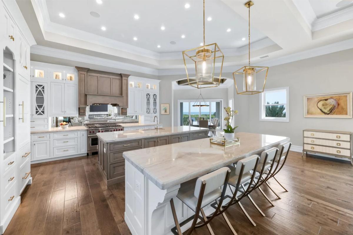 Kitchen with custom cabinetry, counter breakfast bar and a center island prep area.