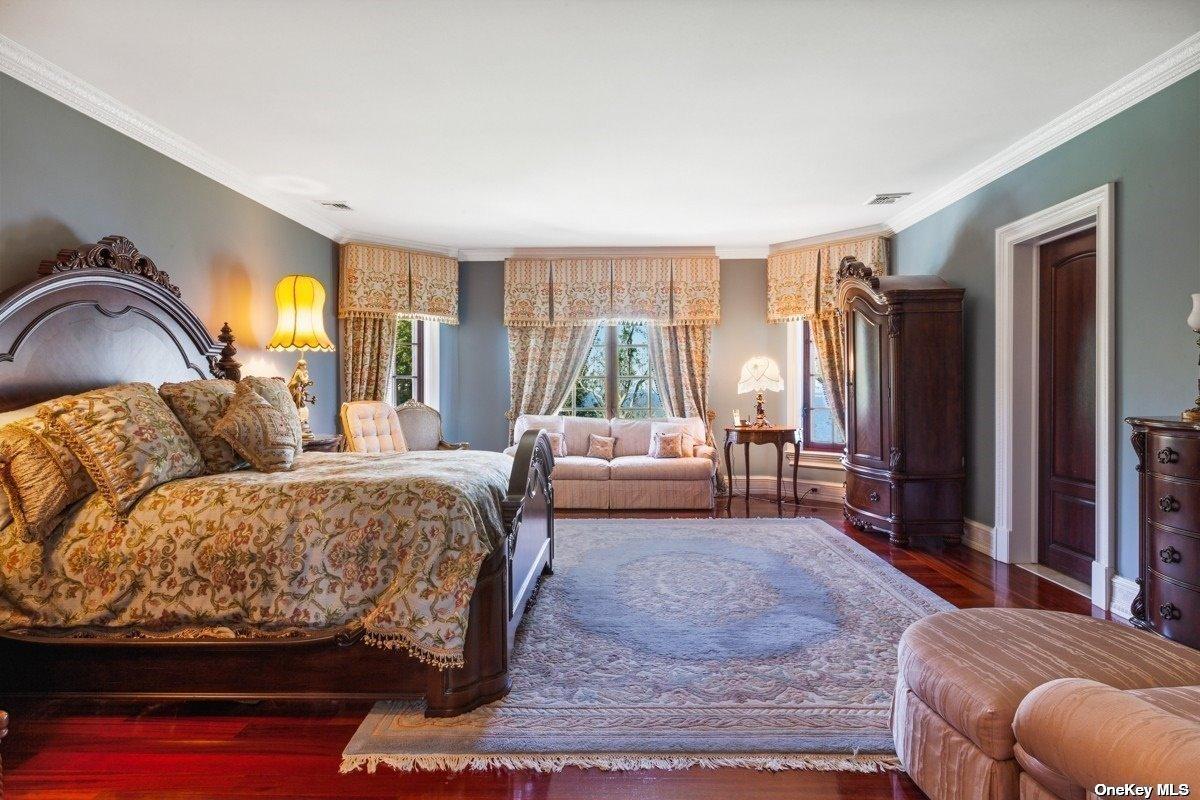 Bedroom with hardwood floors and glass windows.