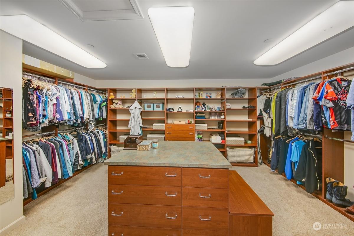 Walk-in closet with carpet flooring.