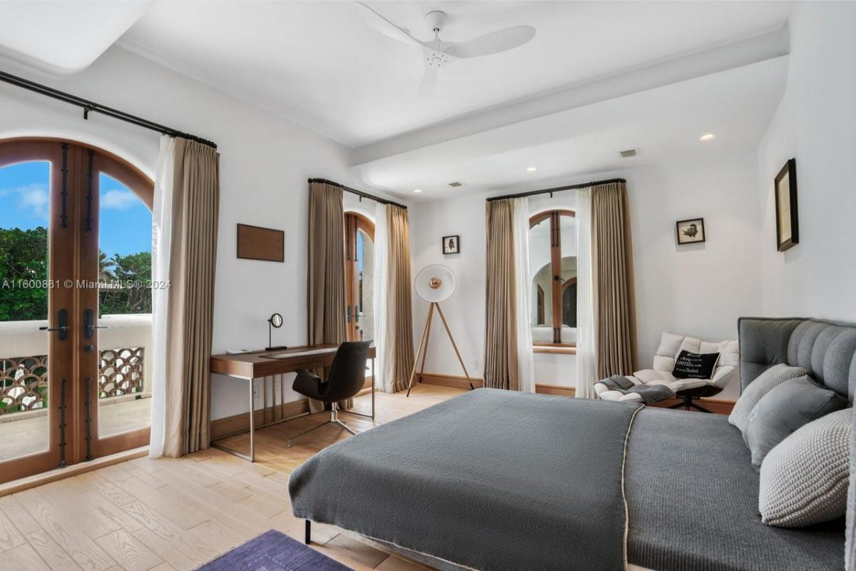 Bedroom with hardwood floors and glass doors.