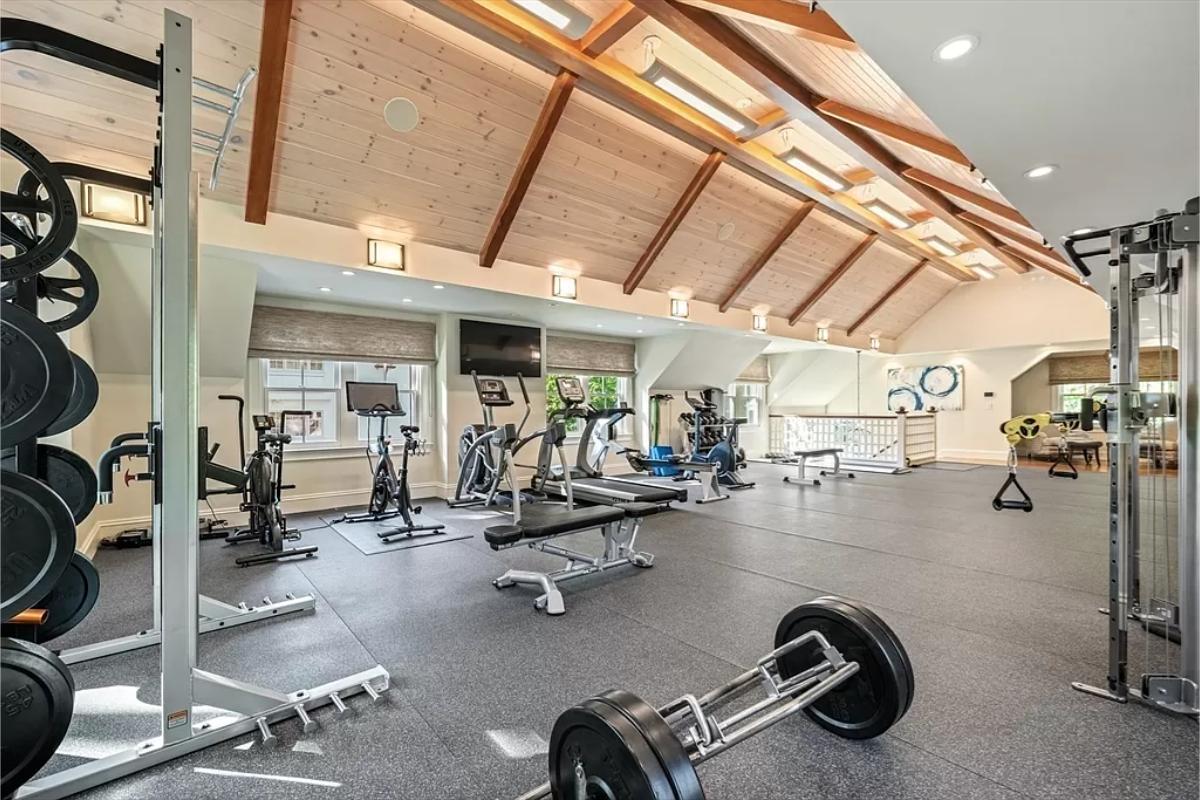 Home gym with lots of workout equipment.