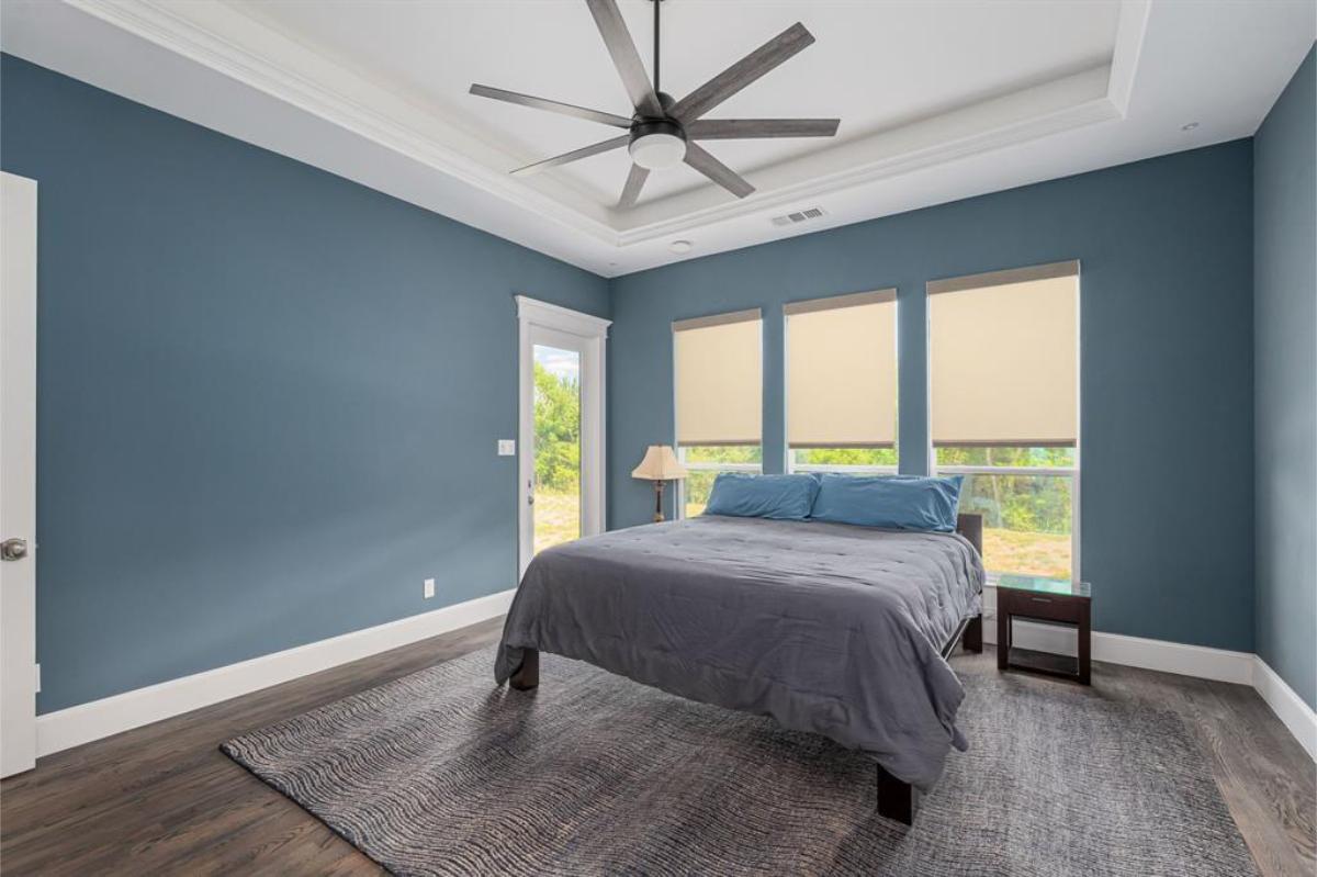 Bedroom with hardwood floors and glass windows.