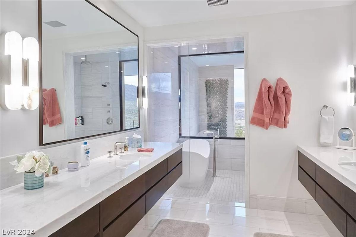 Bathroom with sinks, soaking tub and a walk-in shower.