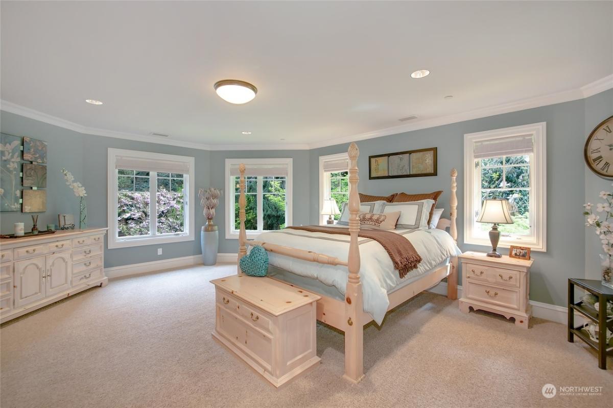 Bedroom with a large bed and carpet flooring.