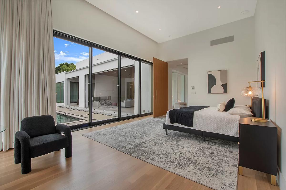 Bedroom with hardwood floors and a large bed.