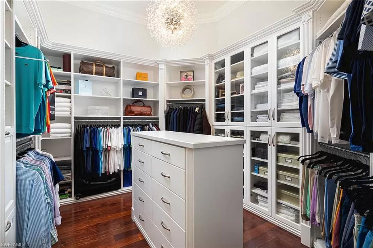 Walk-in closet with a chandelier.