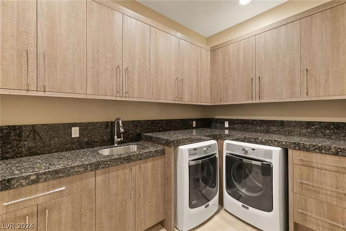 Laundry room with custom cabinetry.