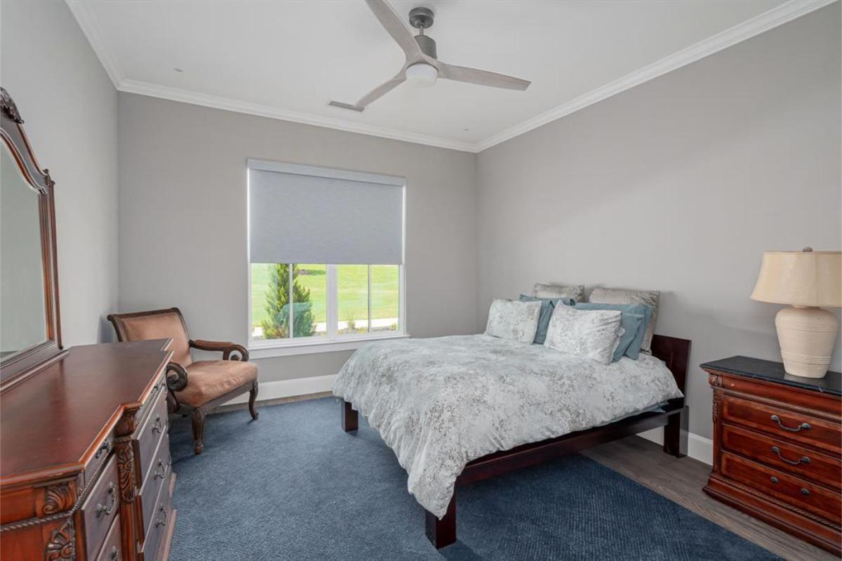 Bedroom with a a large bed and a dresser.