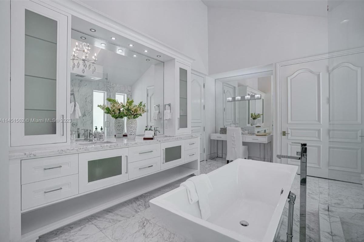 Bathroom with custom-made vanities and a soaking tub.