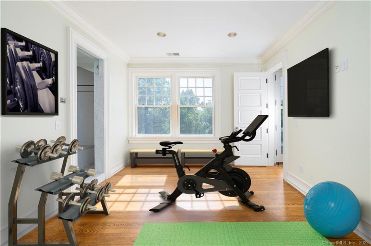 Home gym with a TV.