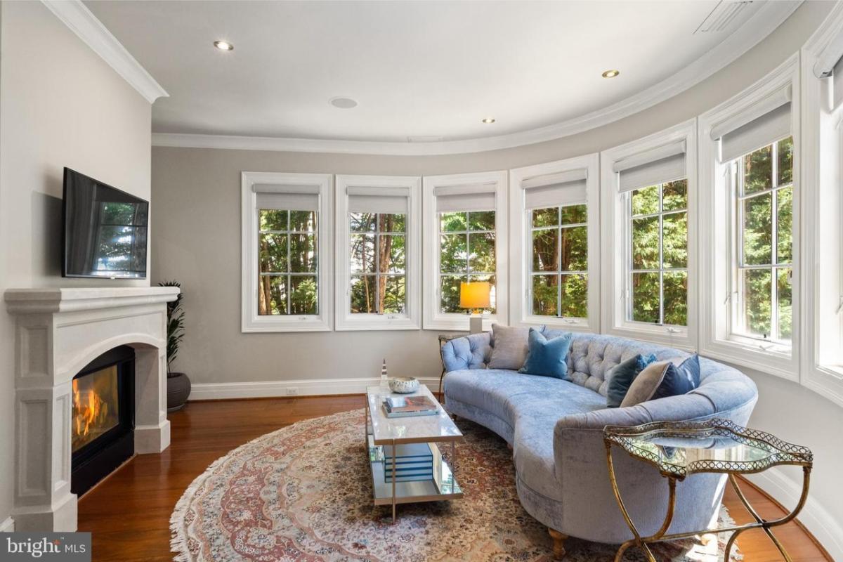 Sitting area with a couch, a TV and a fireplace.