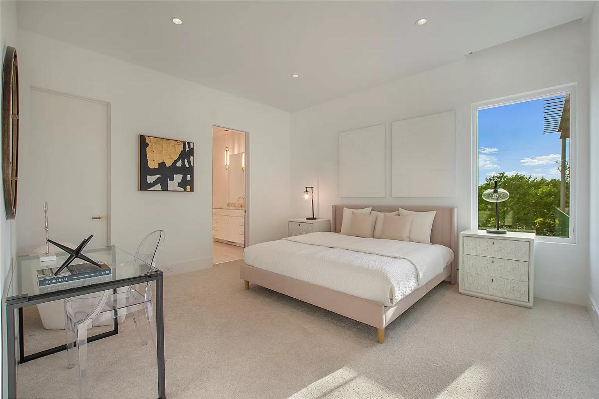 Bedroom with carpet flooring and glass windows..