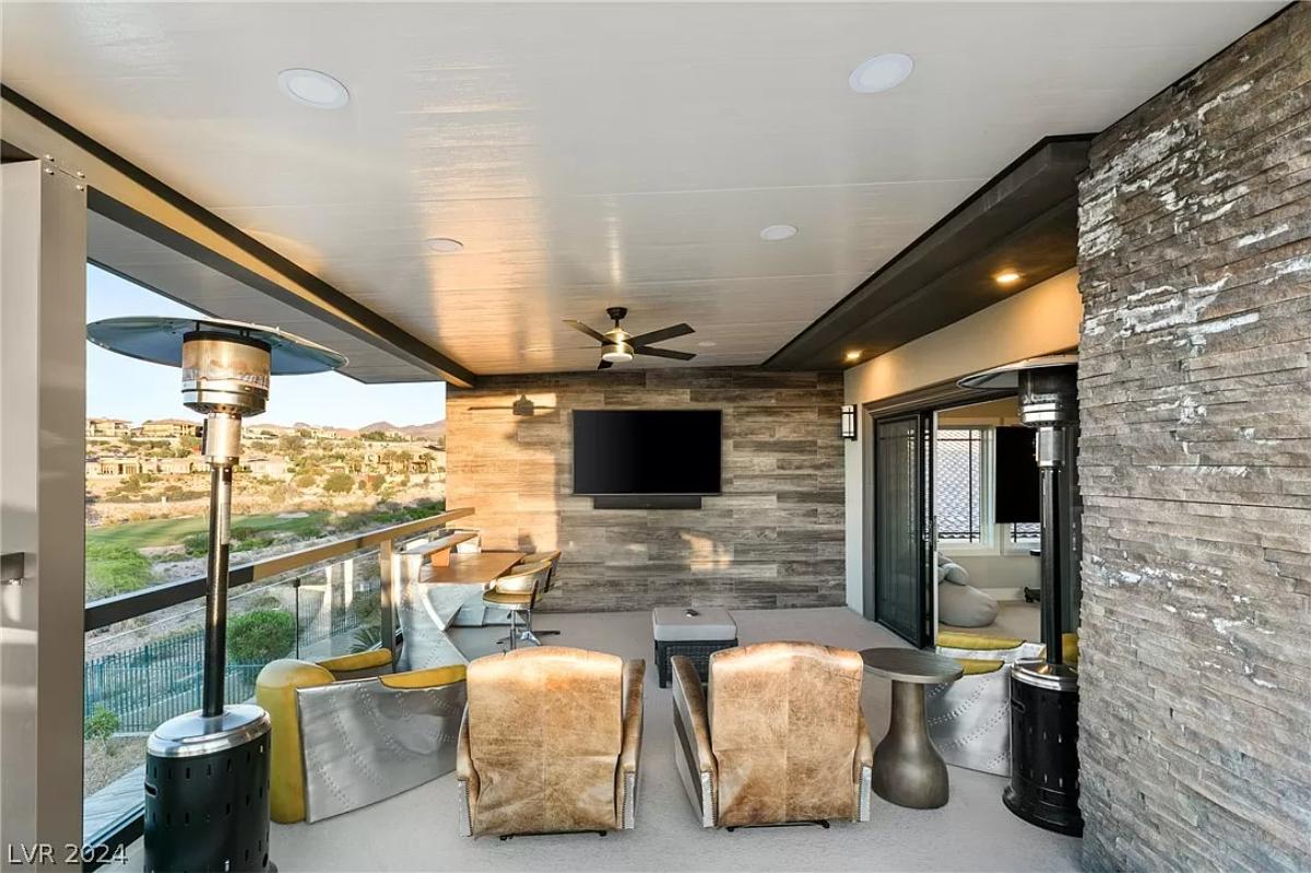 Balcony with couches and a TV.