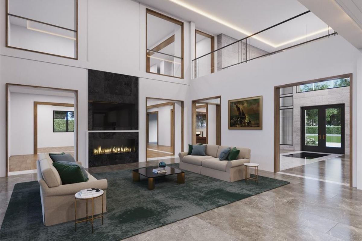 A living room with a TV, a fireplace, a rug, a coffee table, couches, and a center table.