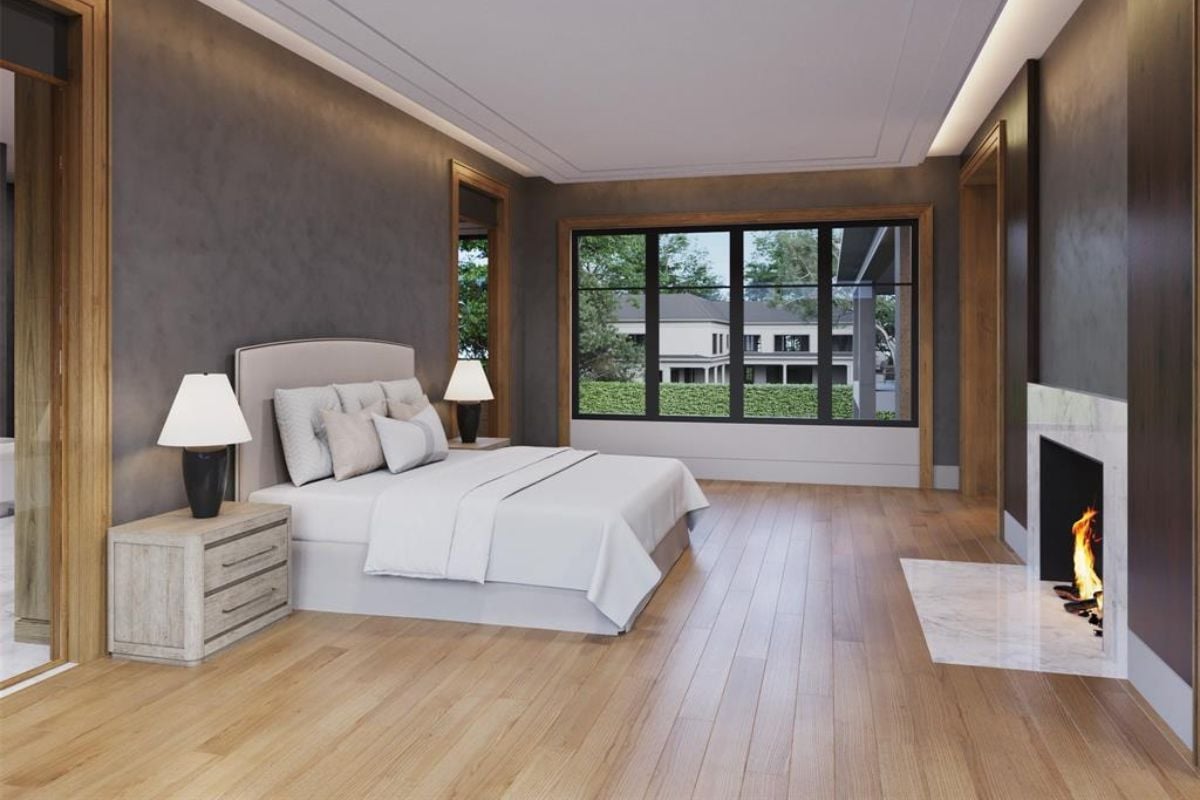 A bedroom with a bed, a window, a fireplace, and a nightstand.