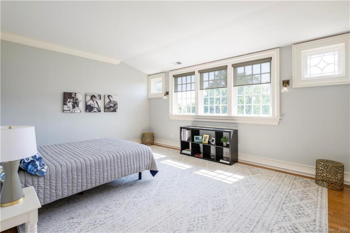 Bedroom with hardwood flooring and glass windows.