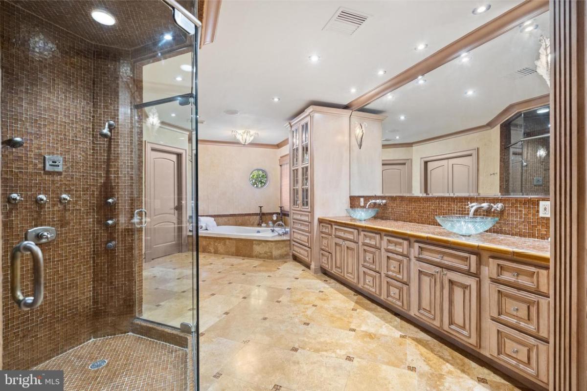 Bathroom with a custom-made vanity, soaking tub and a walk-in shower.
