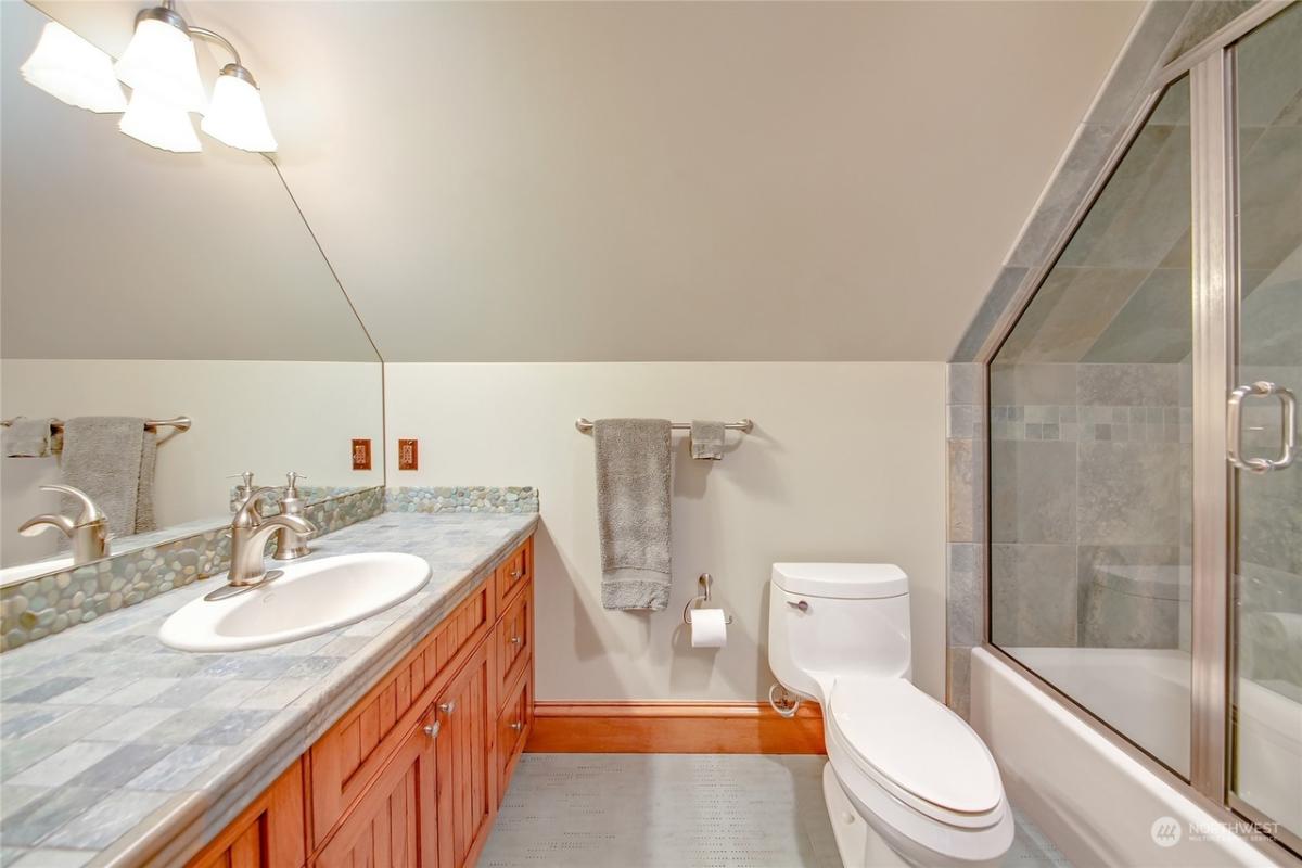 Bathroom with a sink, toilet and a walk-in shower.