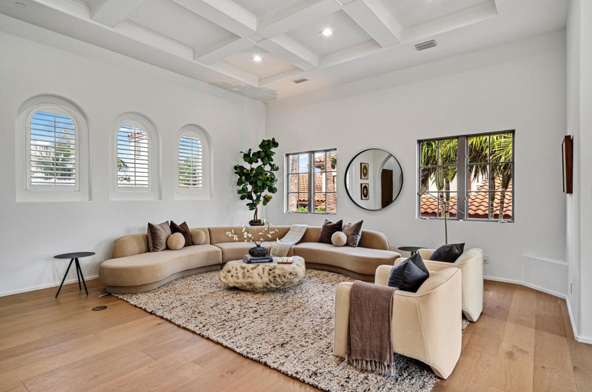 Living room with hardwood floors and coffered ceilings.